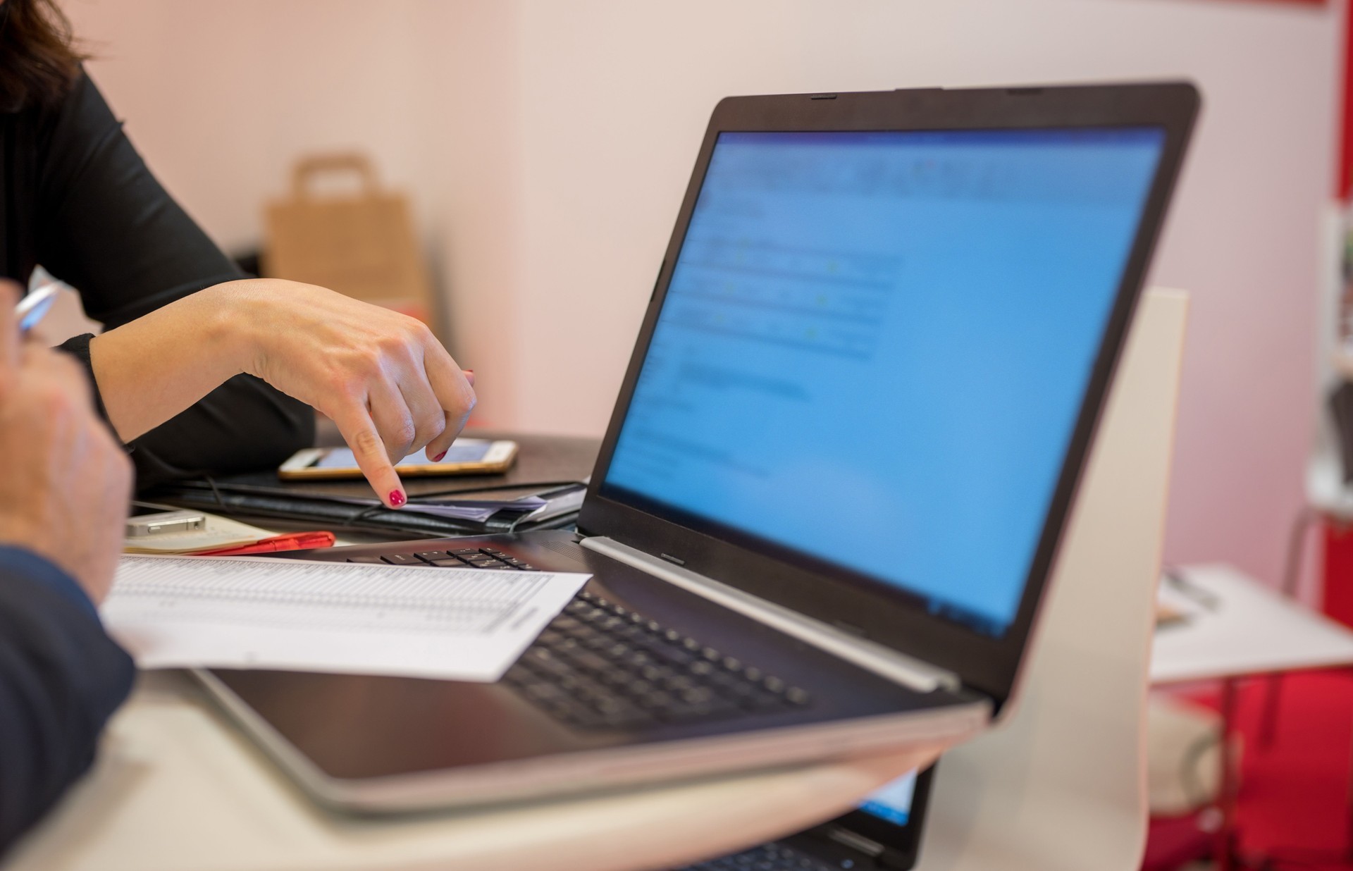 Midsection of business people working on laptop