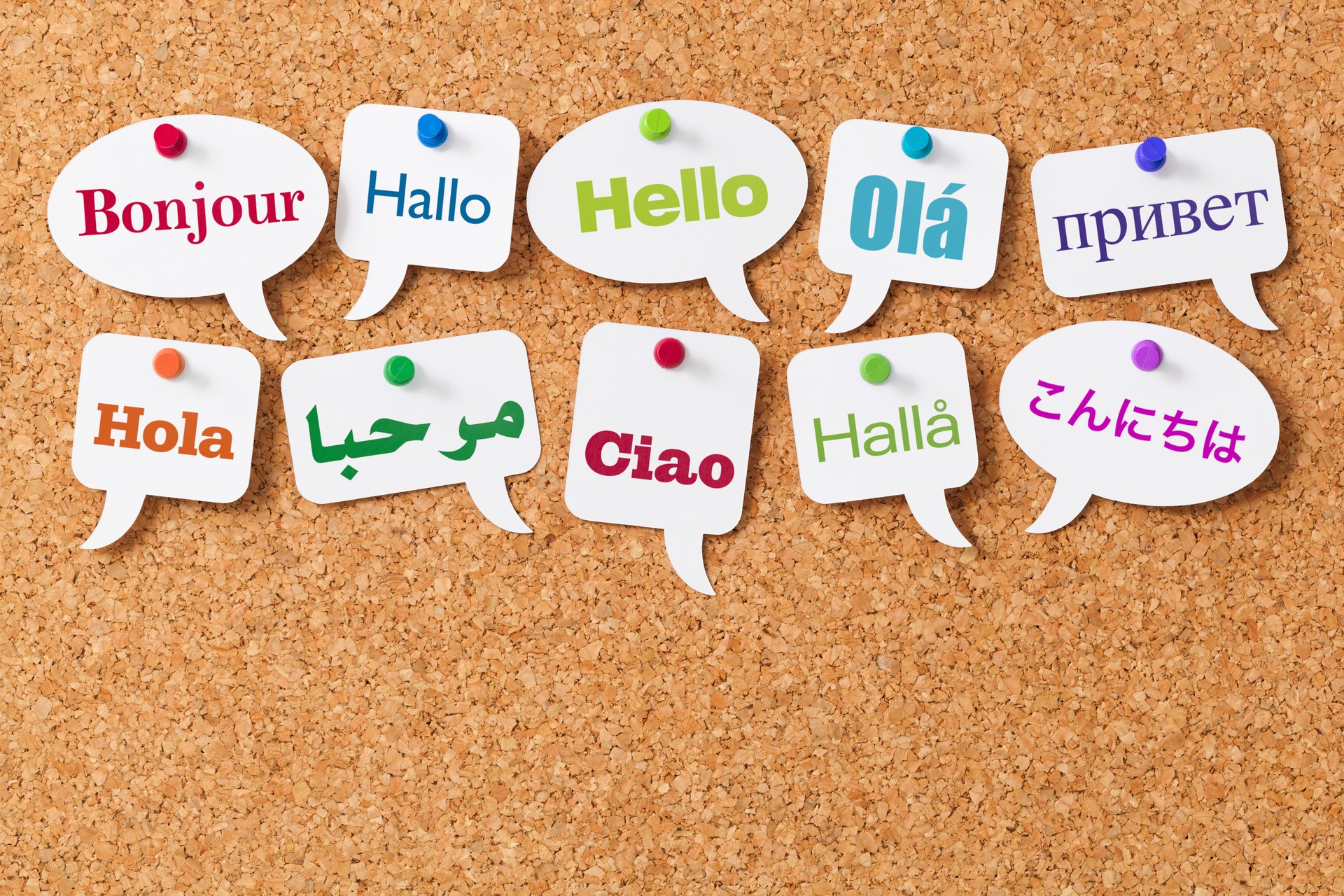 Hello in ten different languages on white speech bubbles